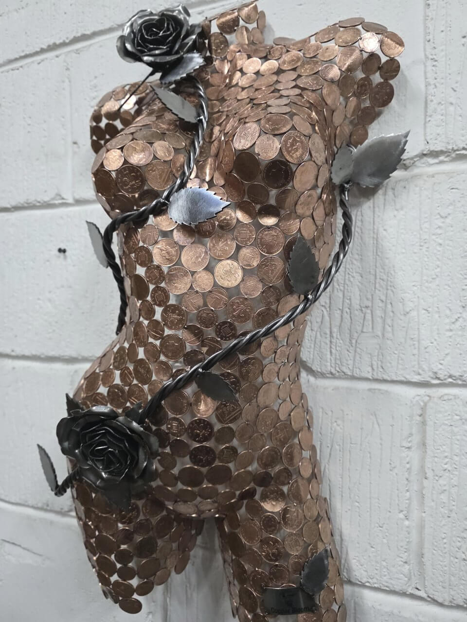 Copper Bloom female torso sculpture made from copper coins and steel roses