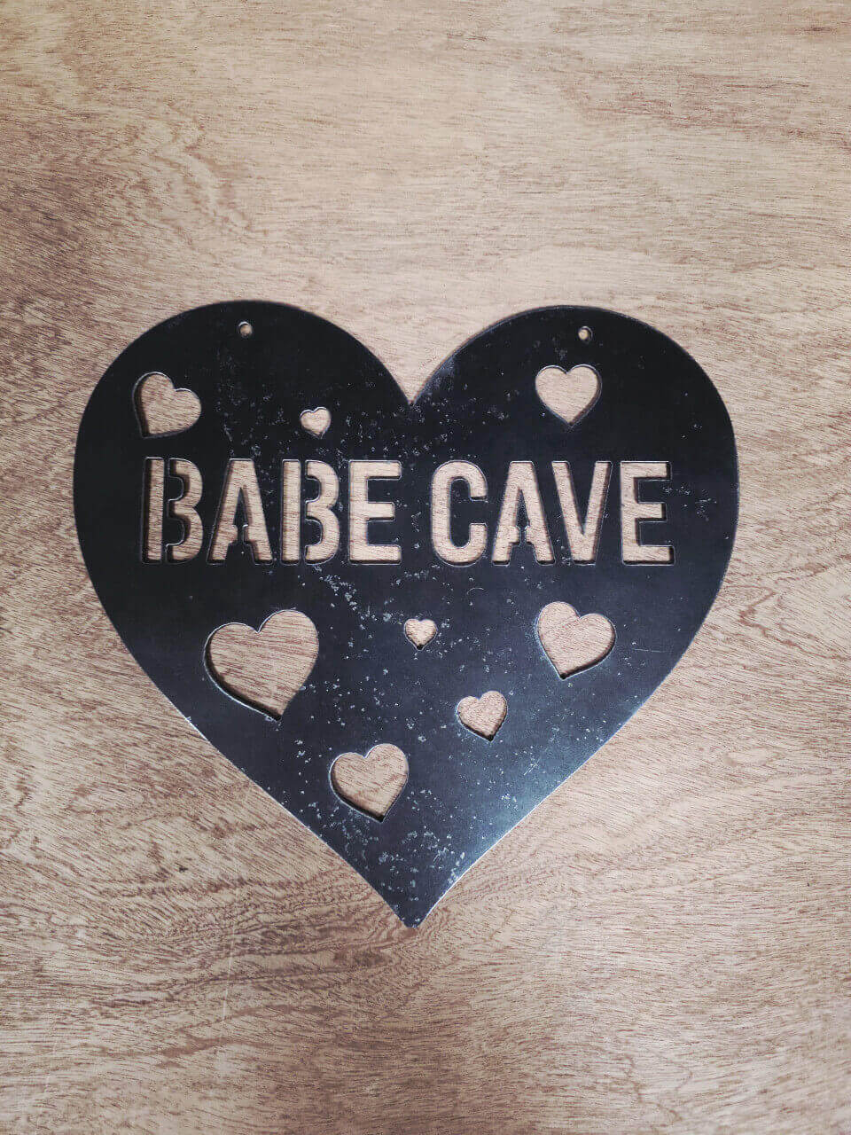 Heart-shaped Babe Cave metal sign cut from raw reclaimed steel