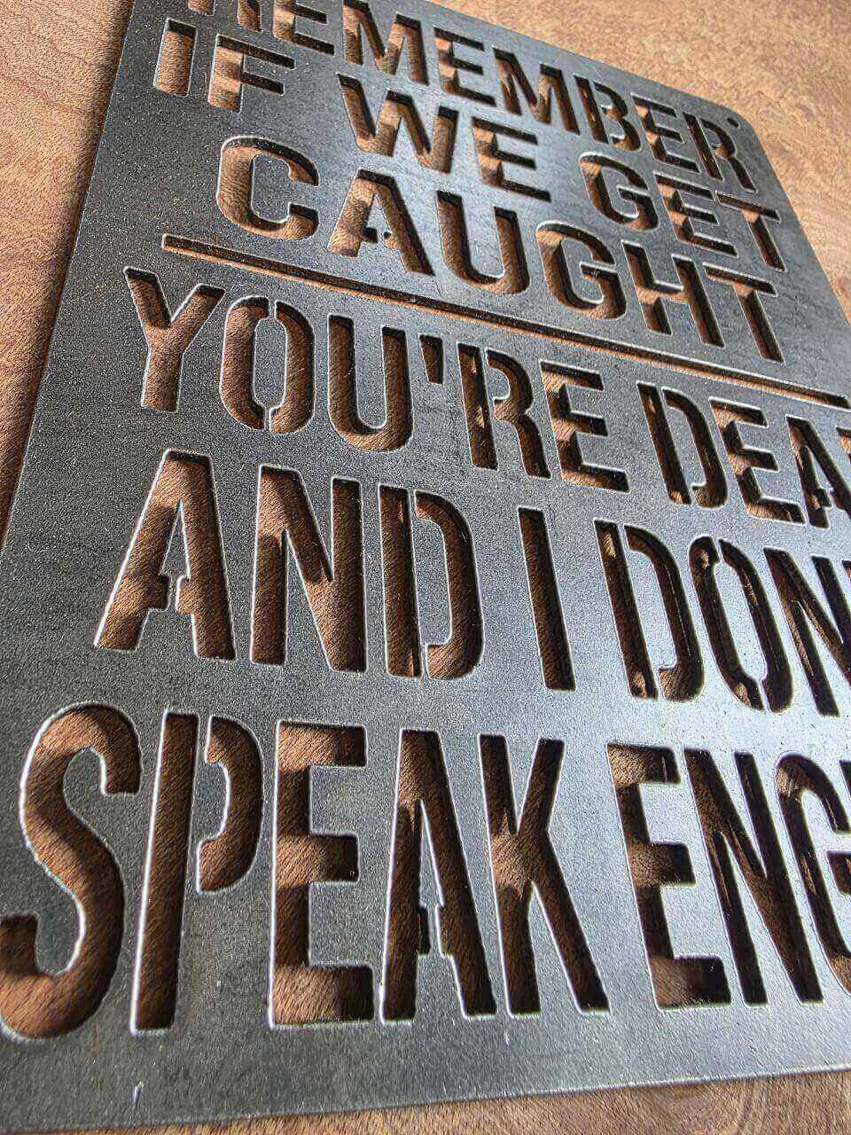 Detail of cut-out lettering on funny novelty metal sign