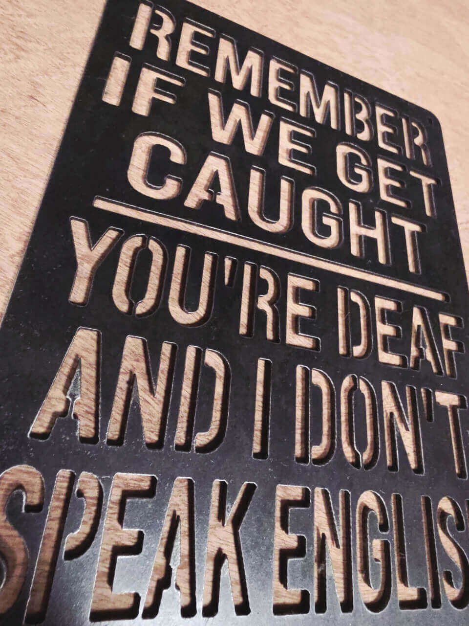 Side-angle view of funny quote raw steel metal sign