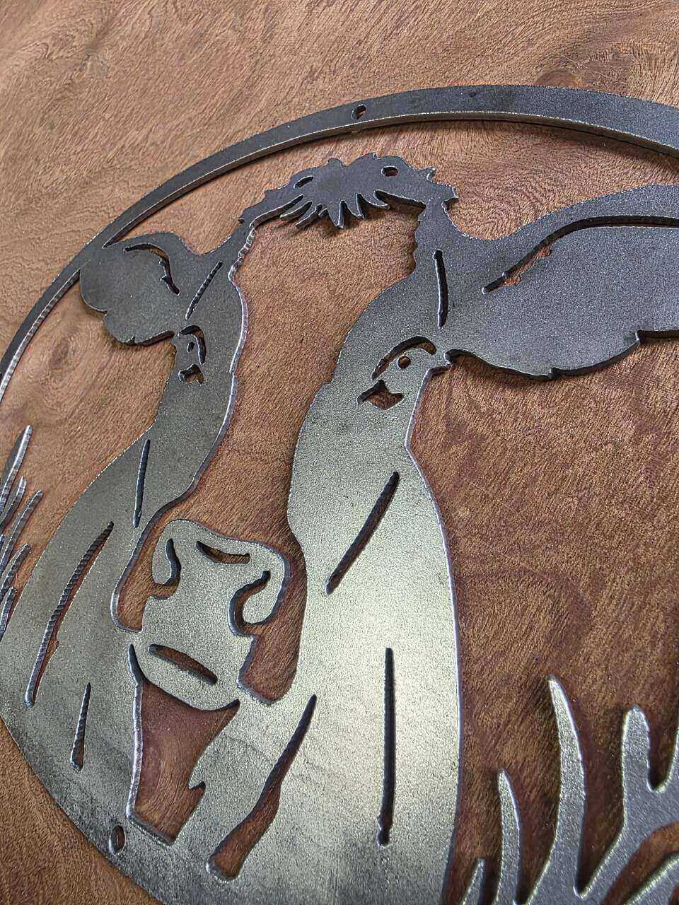 Detail of raw steel cow sign and mounting holes