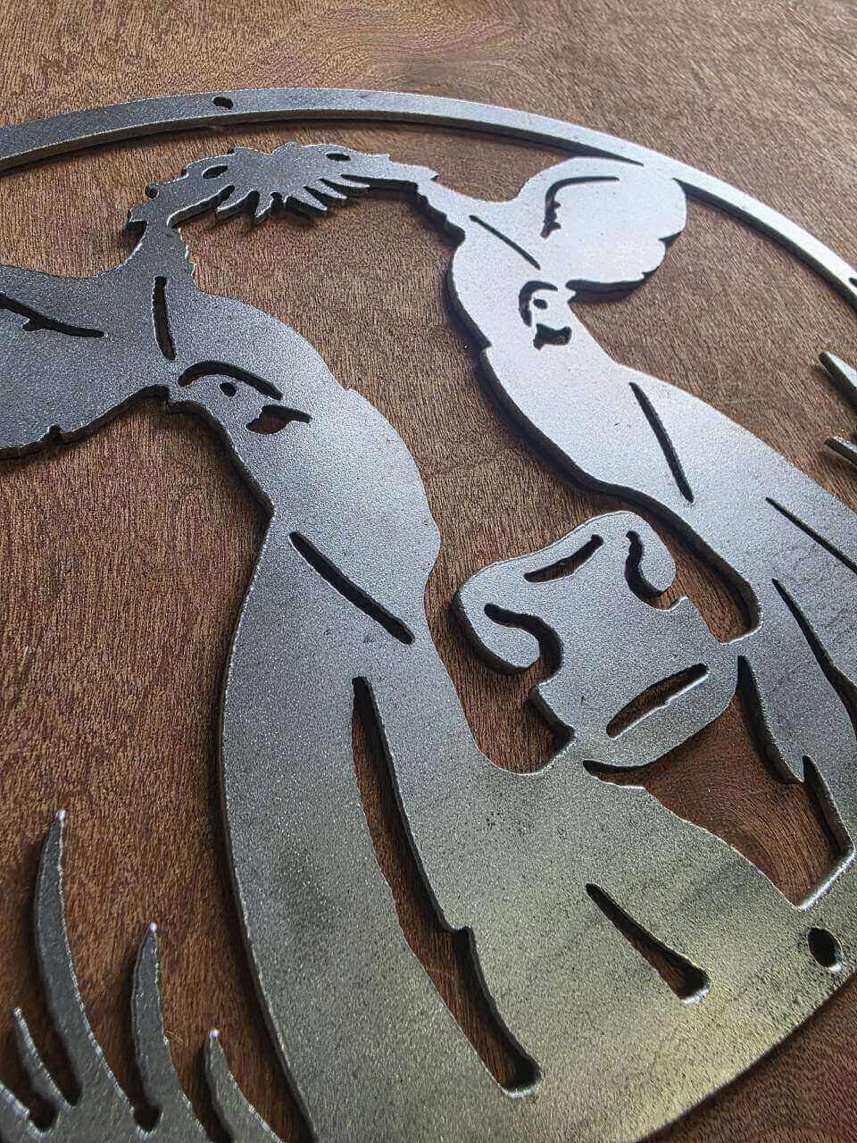 Side-angle detail showing the raw steel cow sign