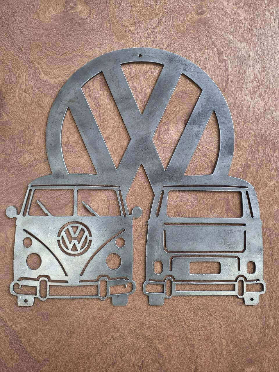 Raw steel VW Camper wall art with the front on the left, rear on the right and VW logo behind
