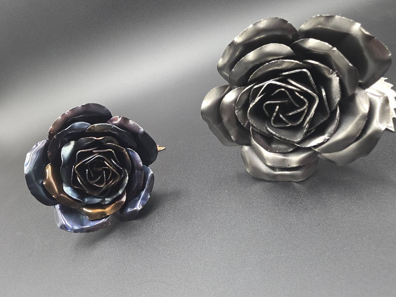 Raw-steel and heat-treated handmade rose heads showing their different finishes