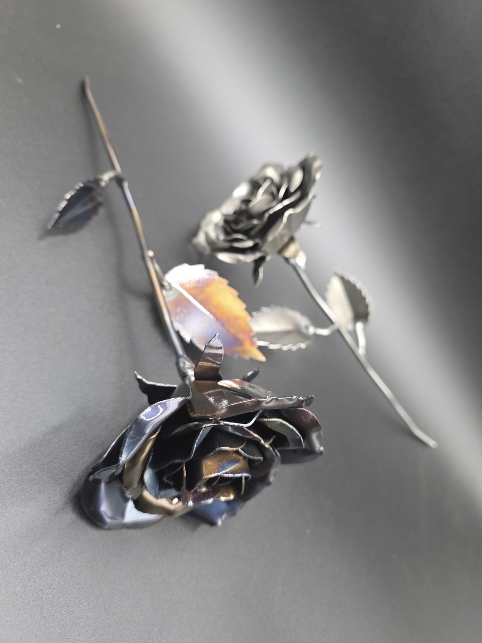 Hand-formed steel roses with metal stems and individually shaped leaves