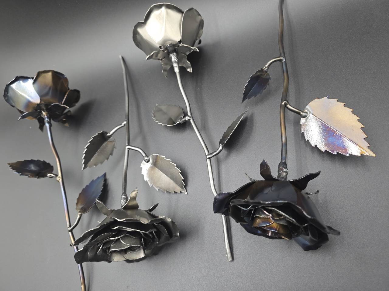 Back of raw-steel and heat-treated roses showing their handmade metal construction