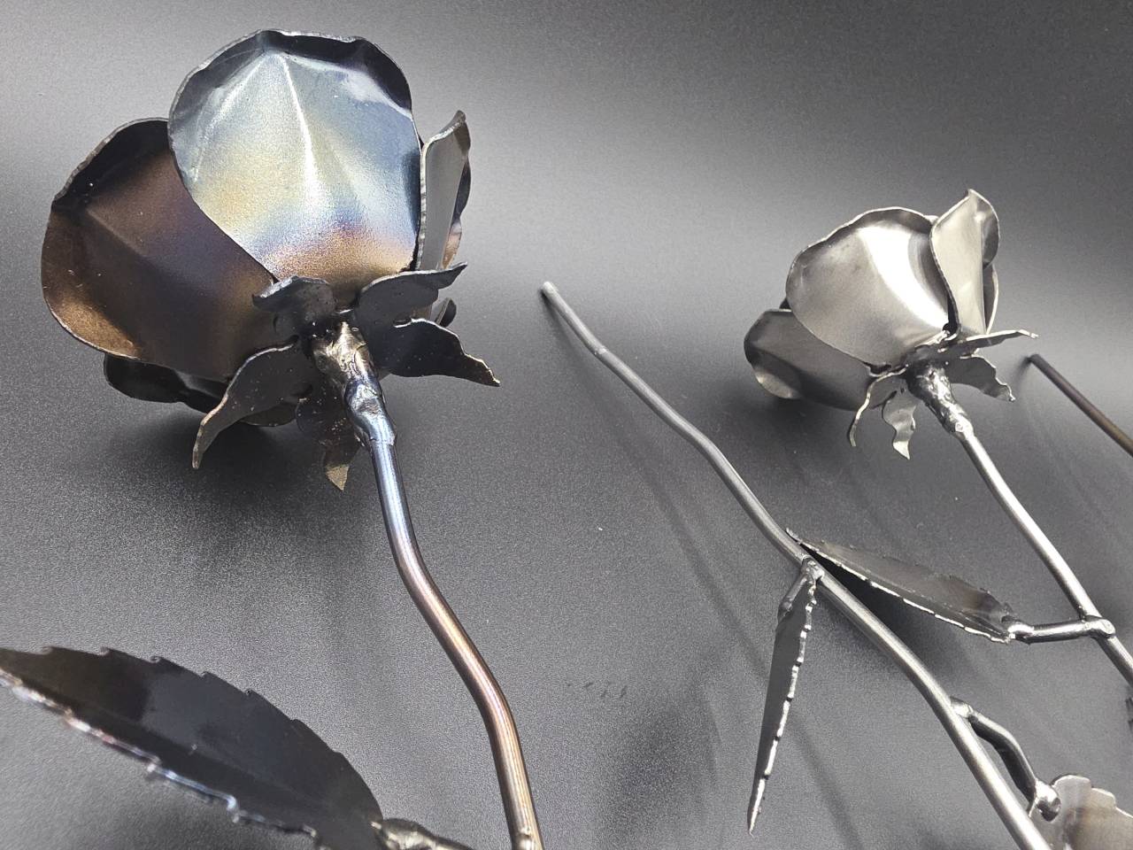 Close rear view of Eternal Steel Rose heads attached to their shaped metal stems