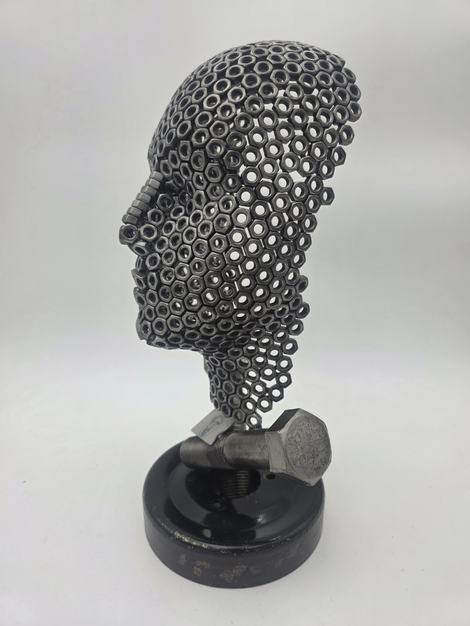 Side view of Fred the Head sculpture showing the M6 nut face and crossed bolt supports