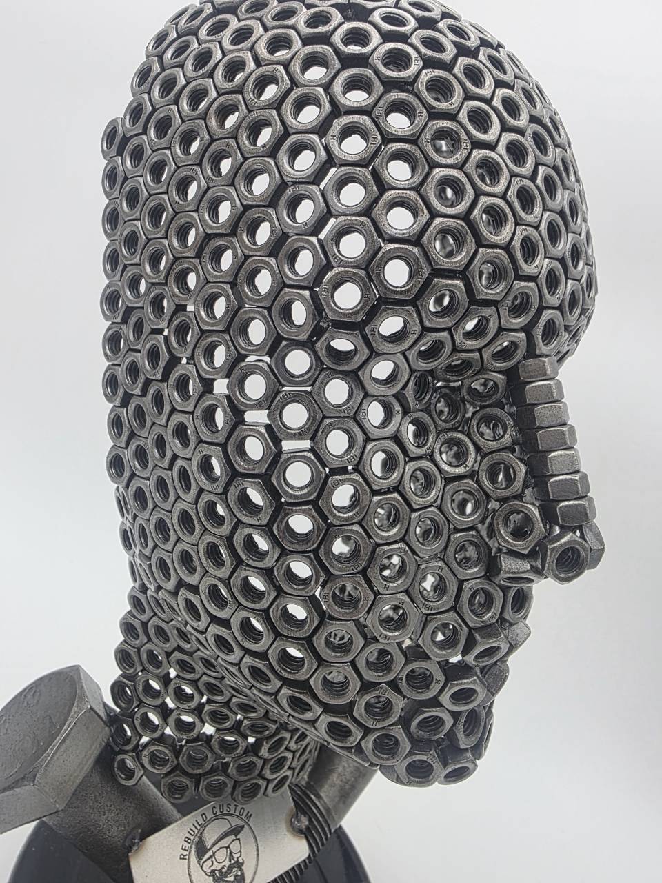 Close-up front view of Fred the Head showing the eyes, nose and mouth formed from welded M6 nuts