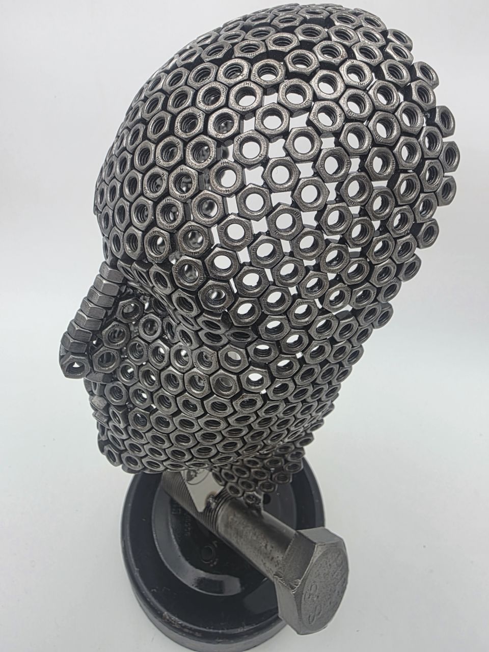 Rear three-quarter view of Fred the Head showing the open welded nut construction