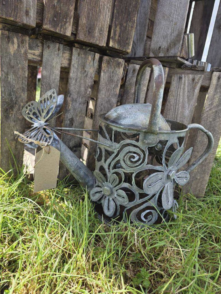 Upcycled metal watering can with handmade flower and butterfly decorations