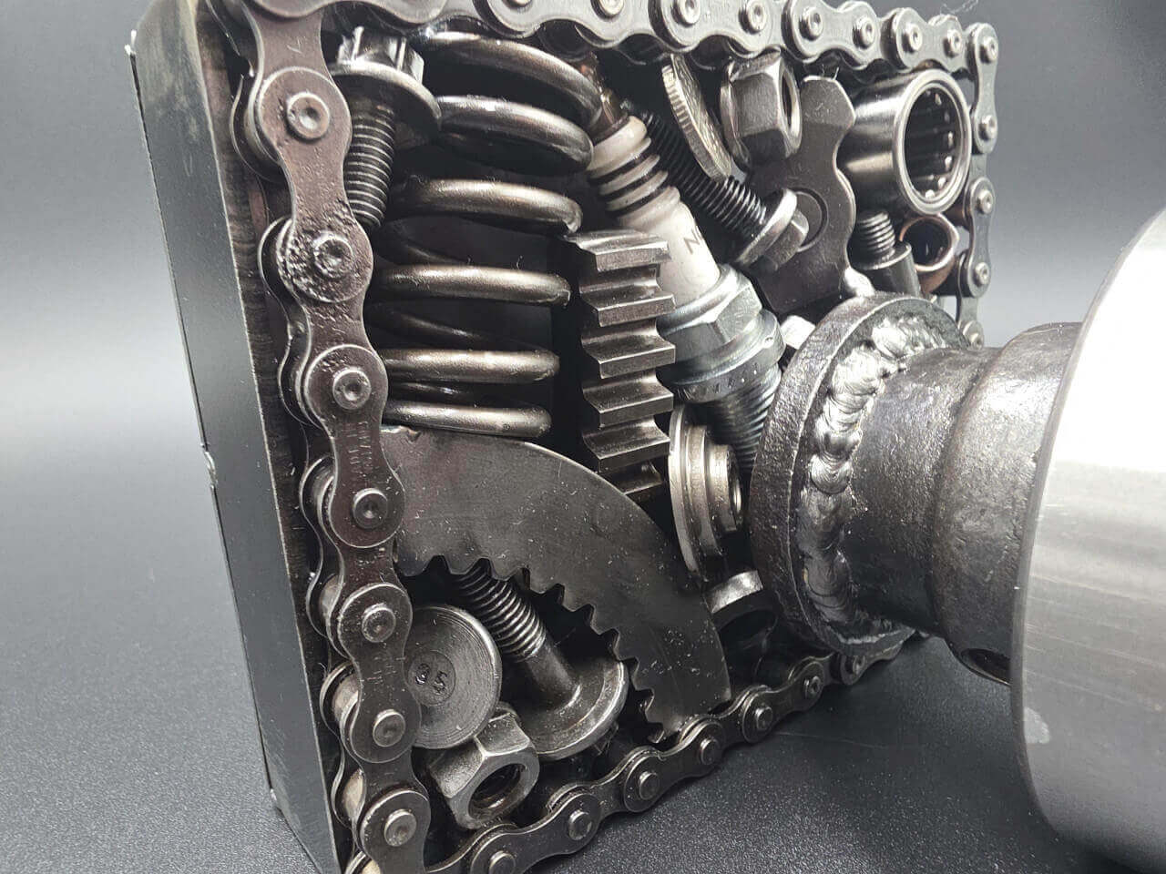 Close-up of chains, springs and reclaimed components used in the camera sculpture