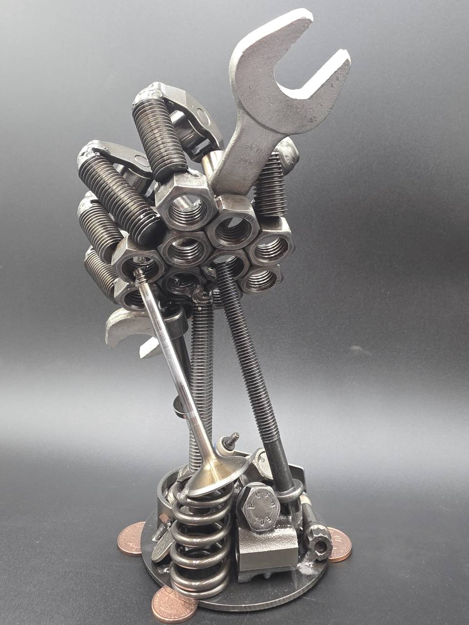 Rear view of the scrap metal hand sculpture with steel fingers and spanner