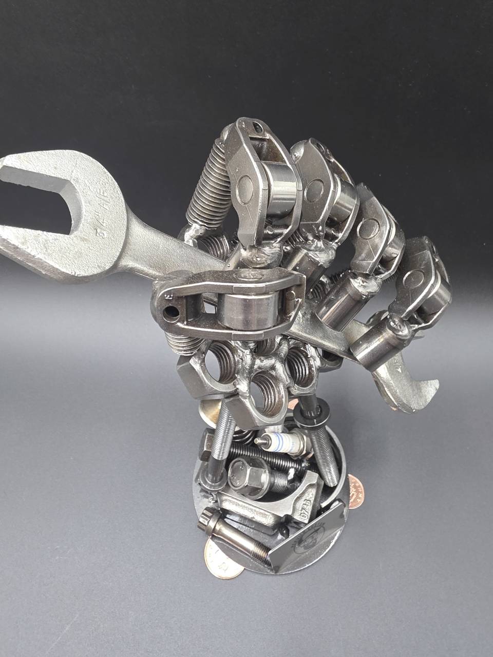 Elevated side view of the steel mechanic’s hand and spanner sculpture