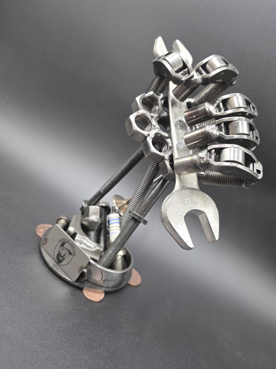 Three-quarter front view of the reclaimed steel hand sculpture for indoor display