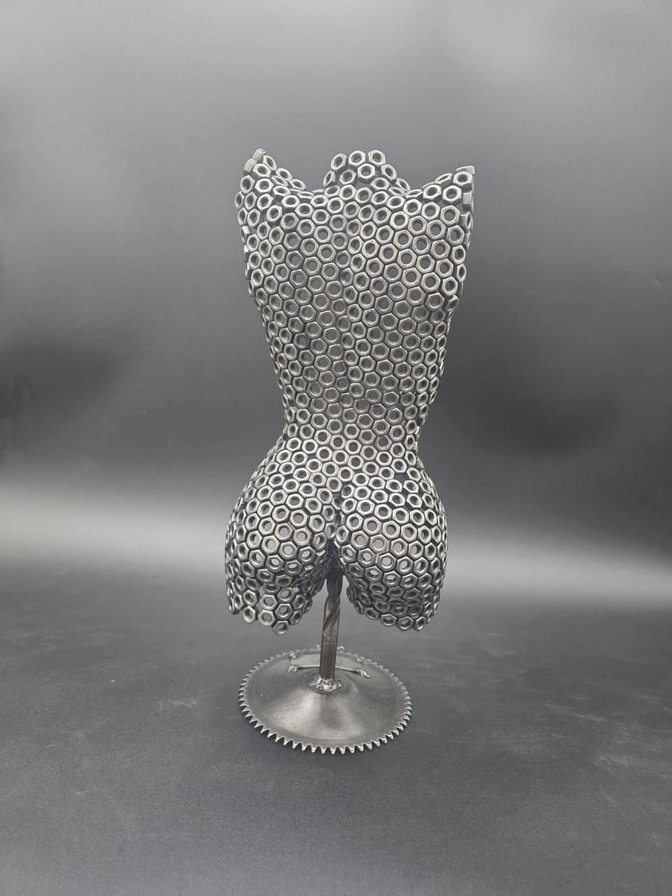 Rear view of the Small Nut Torso sculpture handmade from reclaimed M6 steel nuts