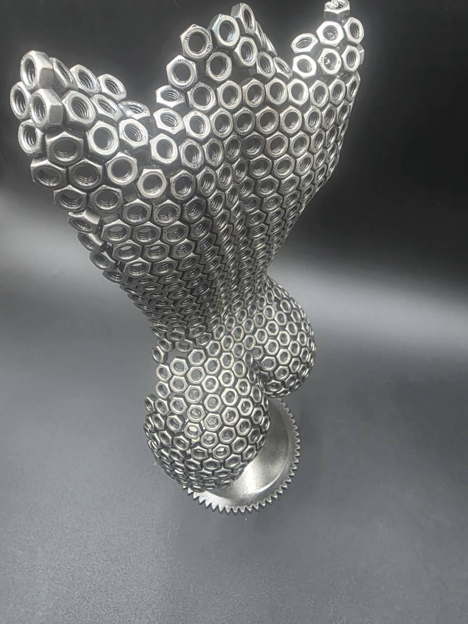 High-angle view showing the open M6 nut construction and curved rear torso form