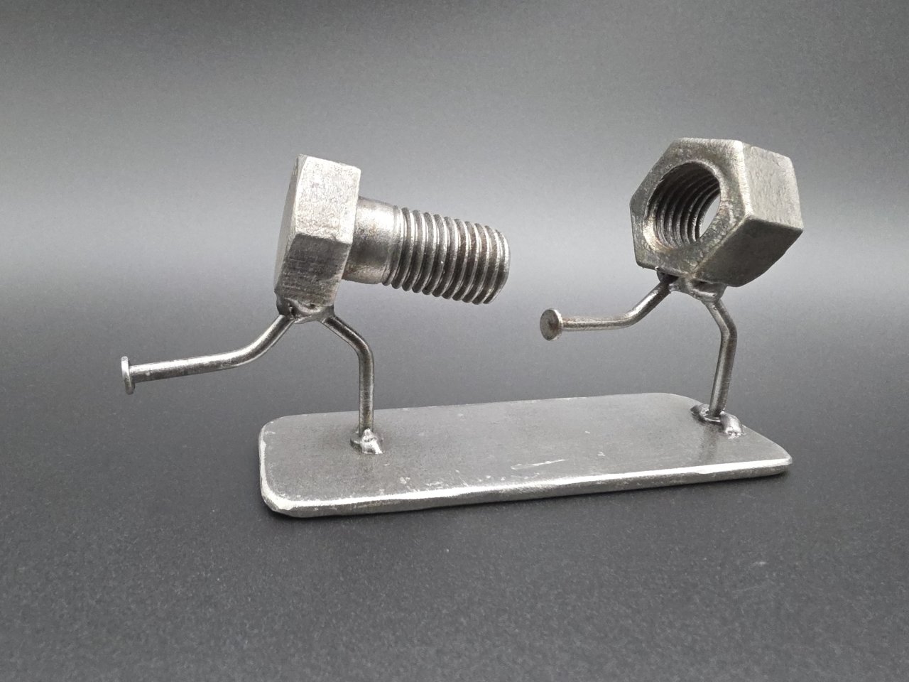 Side view of The Chase funny nut and bolt desk ornament